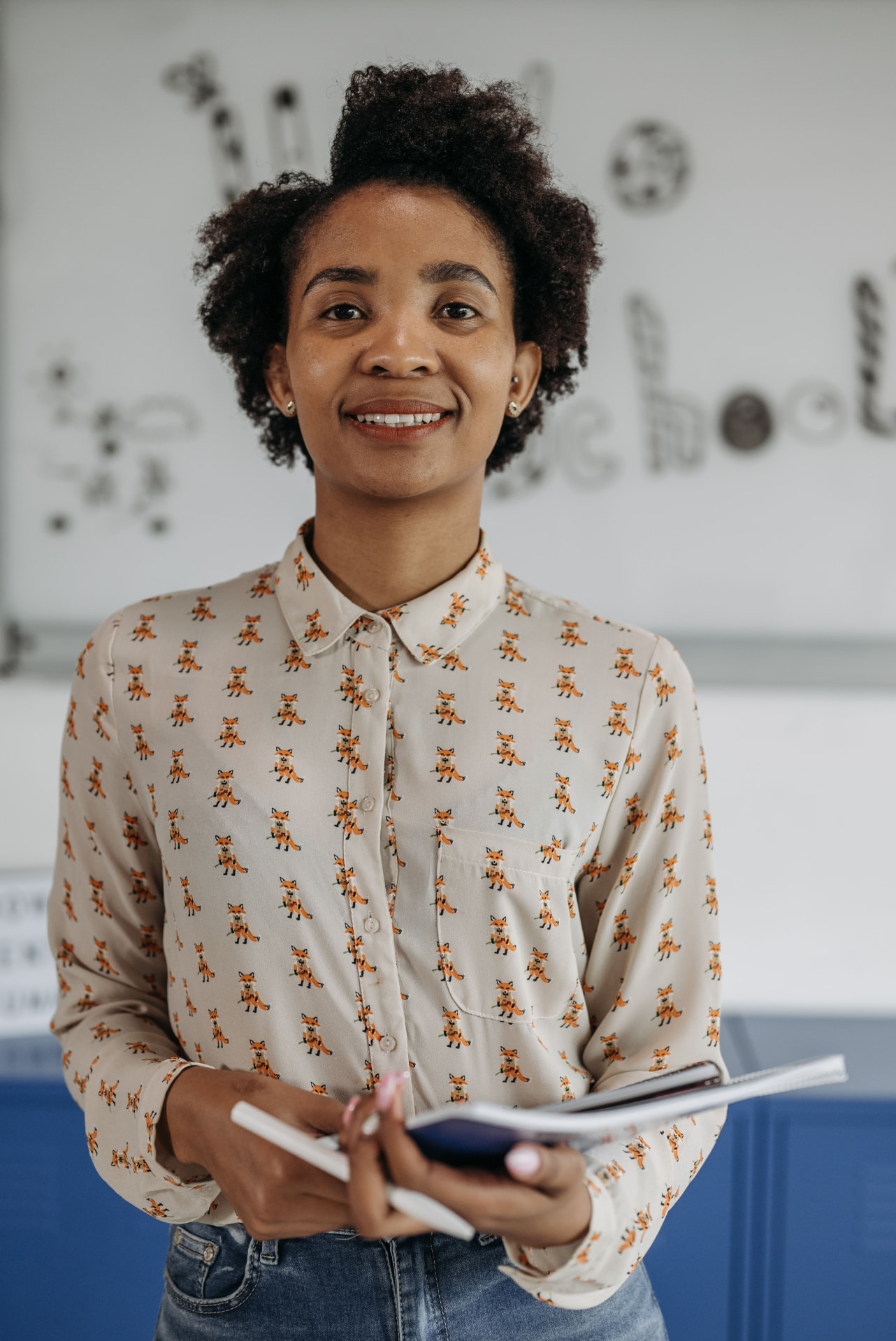 A teacher writing notes at a desk